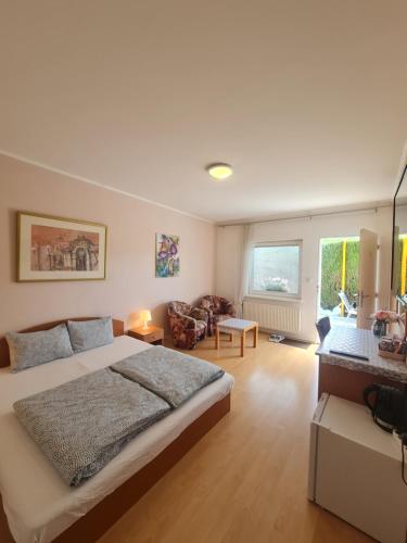 a bedroom with a large bed and a living room at Cozy Room with garden in Bratislava in Bratislava
