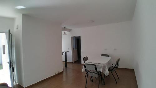 a table and chairs in a room with a white wall at Marcos Juárez 1 in Marcos Juárez