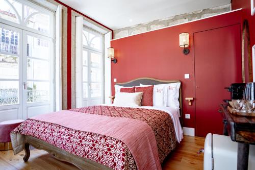 a red bedroom with a bed with red walls at Authentic Porto Suites in Porto