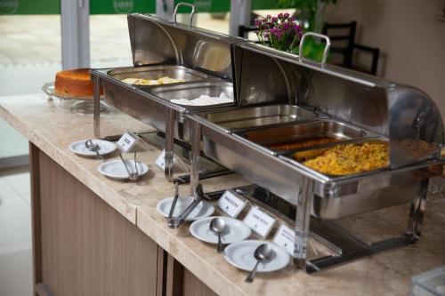 a buffet line with many different types of food at Oasis Hotel in Cajazeiras