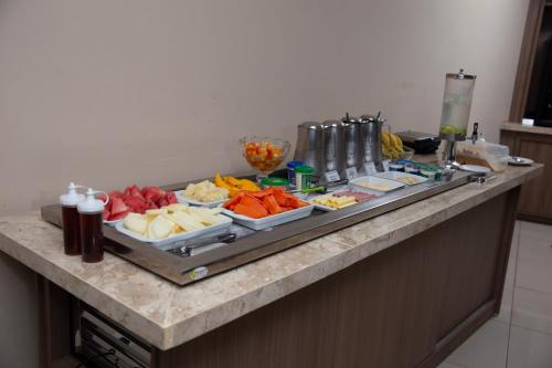 a buffet with many plates of food on a counter at Oasis Hotel in Cajazeiras