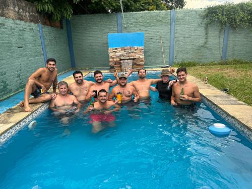 a group of men in a swimming pool at Departamento premium 3 hab in Asunción