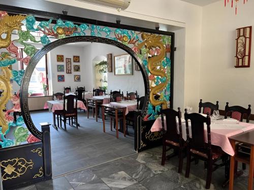 a large mirror in a restaurant with tables and chairs at Today Appartement in Chippis