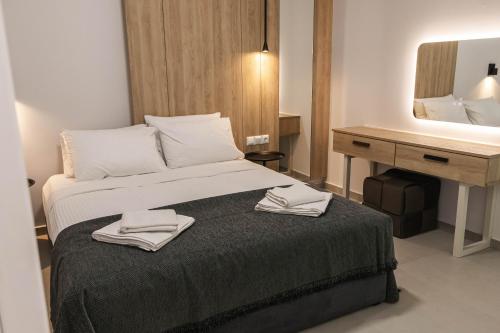 a hotel room with a bed with two towels on it at Harmony Luxury 1 in Ierápetra