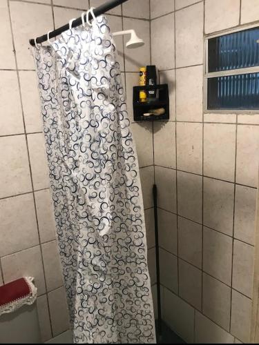 a shower curtain is hanging in a bathroom at Traveler gu's room AP compartilhado in Fortaleza