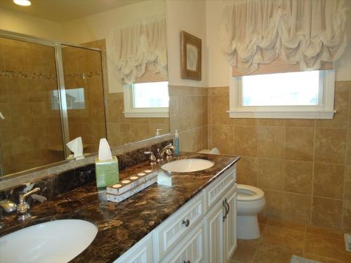 a bathroom with two sinks and a toilet at Peachbrook, Llc in Brant Beach