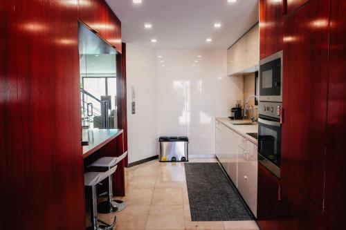a kitchen with white cabinets and a stove top oven at Marlages House in Lavra