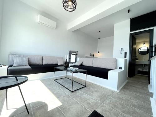 a living room with a couch and a table at Amenti Horizon View in Agkidia