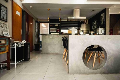 a kitchen with a fireplace in the middle of a room at Casanova Residence in Rio de Janeiro