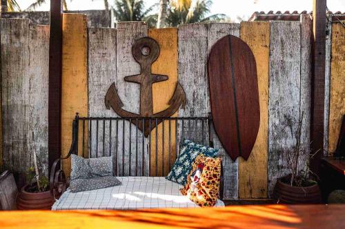 a wooden fence with a bed with an anchor on it at Casanova Residence - Barra da Tijuca na Ilha da Gigoia in Rio de Janeiro
