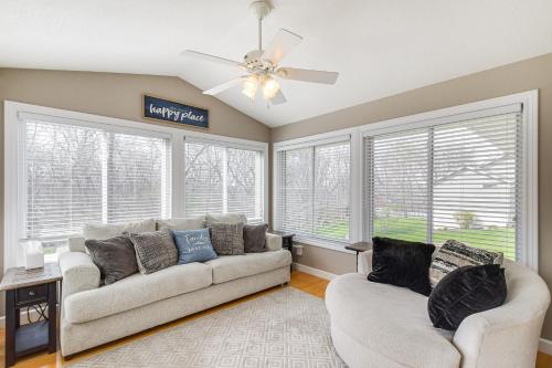 a living room with two couches and a ceiling fan at Rock Island Home with Private Yard and Fire Pit Table! in Rock Island