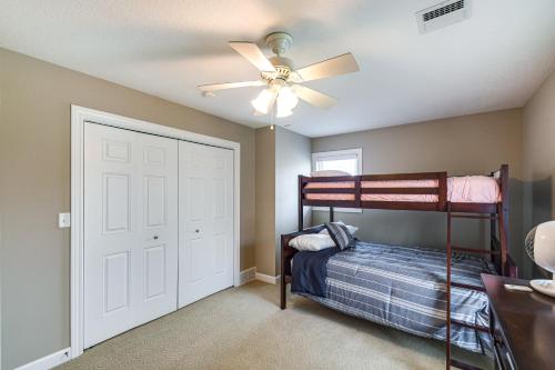 a bedroom with a bunk bed and a ceiling fan at Rock Island Home with Private Yard and Fire Pit Table! in Rock Island