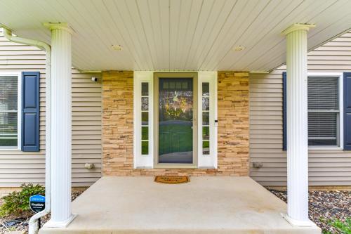 a front door of a house with two columns at Rock Island Home with Private Yard and Fire Pit Table! in Rock Island