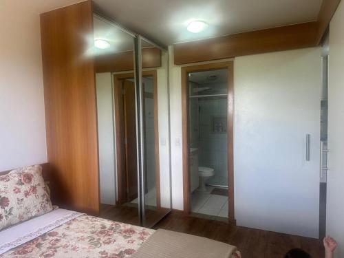 a bedroom with a bed and a bathroom with a shower at LIFE RESORT PROXIMO PALACIO PLANALTO E ESPLANADA DOS MINISTERIOS in Brasilia