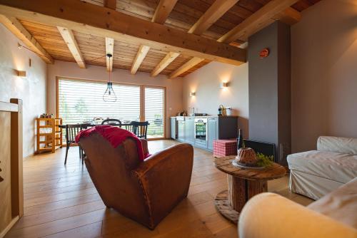 a living room with a couch and a table at Le Holzberg et ses Suites in Osenbach