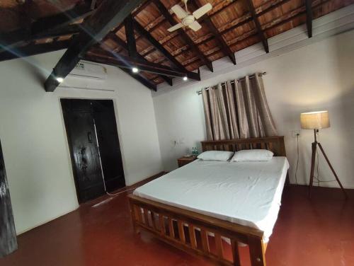a bedroom with a large bed in a room at Sukūn Heritage -A traditional 4 Bedroom Vacation Villa in Kannur