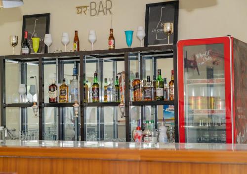 a bar with a lot of bottles of alcohol at Hotel Azur Conakry in Conakry