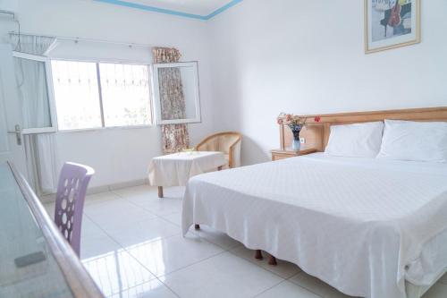 Postel nebo postele na pokoji v ubytování Hotel Azur Conakry