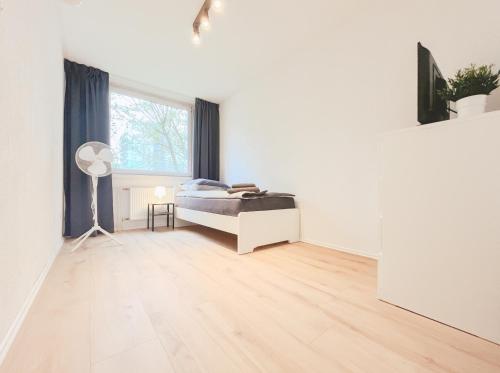 ein weißes Zimmer mit einem Bett und einem Fenster in der Unterkunft Home4Now DOR02 Gemütliche Monteursunterkunft in Dormagen in Dormagen