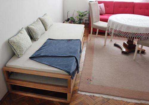 a bed in a room with a table and a couch at The Cosmic Gate Apartments in Visoko