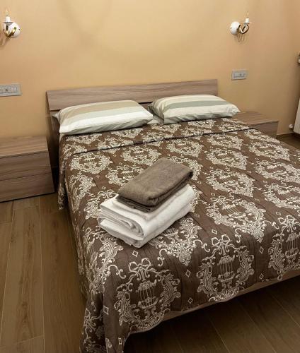 a bedroom with a bed with towels on it at Affittacamere La Quiete in Arona