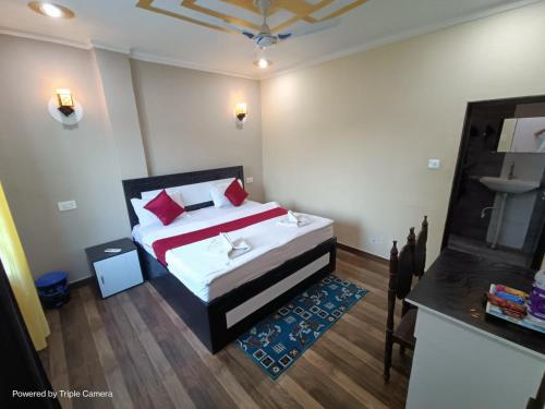 a small bedroom with a bed and a table at Mohit Paying Guest house in Varanasi