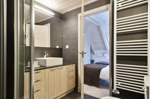 a bathroom with a sink and a mirror at Luderna - Casa Val de Ruda IV des Artiguetes in Baqueira-Beret