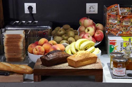 a table with a bunch of bread and fruit on it at Campanile Lyon Centre - Gare Perrache - Confluence in Lyon