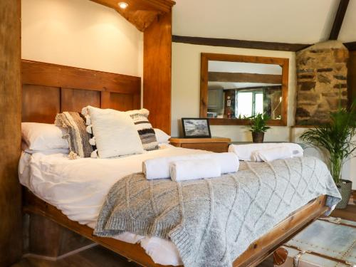 a bedroom with a bed with towels on it at The Roundhouse in Okehampton