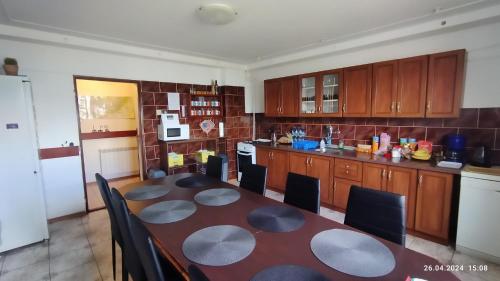 a kitchen with a table and chairs in a room at Lucky Cat in Nová Lesná