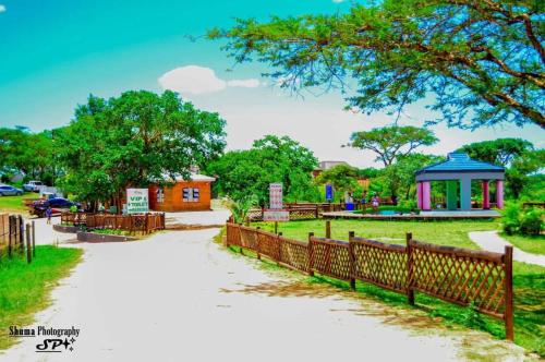 a park with a fence and a gazebo at Elias Nefale Eco Estate in Mitxetweni