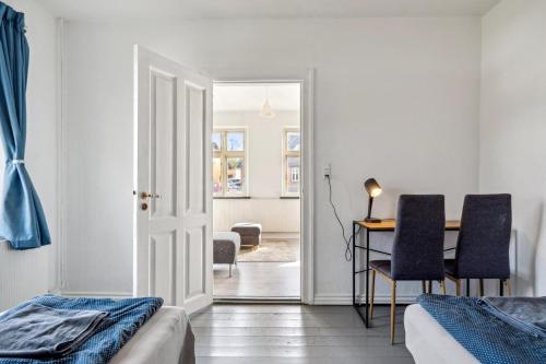 a bedroom with two beds and a table with chairs at Town House in Fuglebjerg in Fuglebjerg