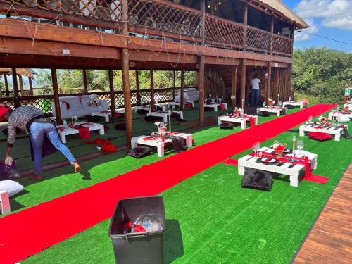 a person standing on a field of green grass with a red stripe at Elias Nefale Eco Estate in Mitxetweni