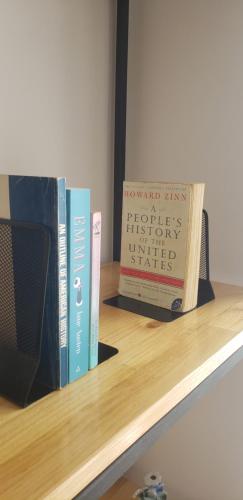 two books sitting on top of a shelf at Pomegranates & Olives Guesthouse in Durrës