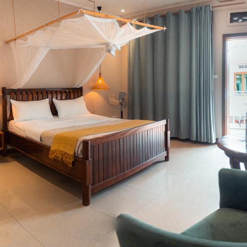 a bedroom with a large bed with a canopy at The Nest in Kigali