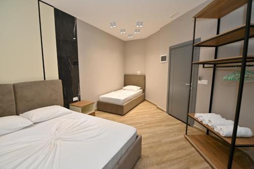 a bedroom with two beds and a bunk bed at MondurO Hotel in Durrës