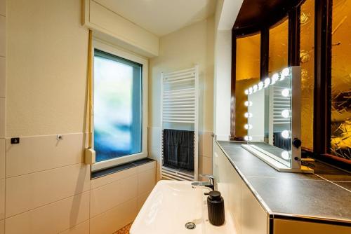 a bathroom with a sink and a mirror at Wohnen in ehemaliger Kneipe in Cologne