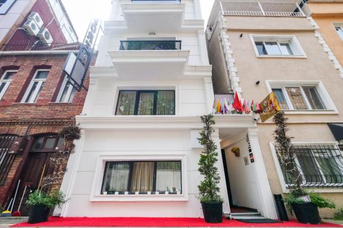 a white house with a red carpet at Loren Hotel&Suites in Istanbul