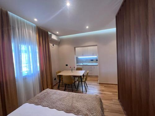 a bedroom with a table and a dining room at Vila Magis in Vlorë