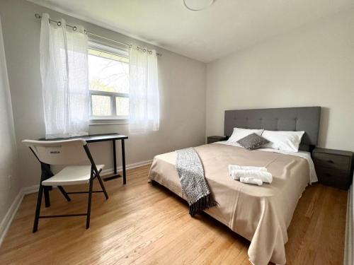 a bedroom with a bed and a desk and a window at ViHome-Queen bedroom near Don Mills Dvp & 401 in Toronto