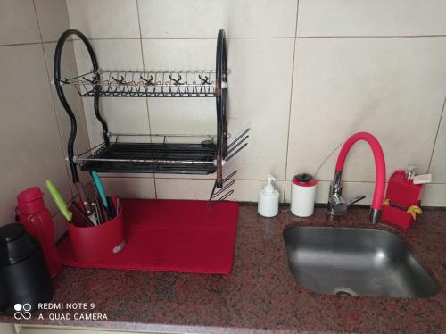 a kitchen counter with a sink and utensils at Habitación privada en apto cat friendly in Montevideo