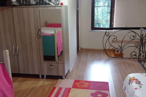 a room with a small cabinet with a table and a rug at HAS Bağ Evi 