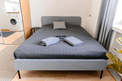 a bed with two pillows on it in a room at Nordstay - Stylish Central Studio self check-in in Helsinki