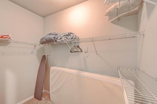 a laundry room with a shower and a shelf at Cozy Modern Apartment with patio and pool. in Houston