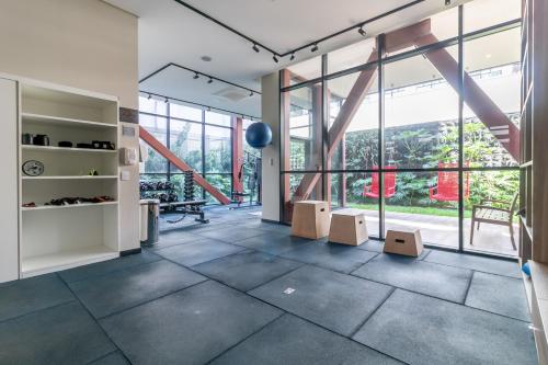 a room with a floor to ceiling windows and a staircase at 360 Suítes Vila Mariana - Apartamentos mobiliados in Sao Paulo