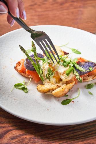 a person eating a plate of food with a fork at Homestead Resort in Midway