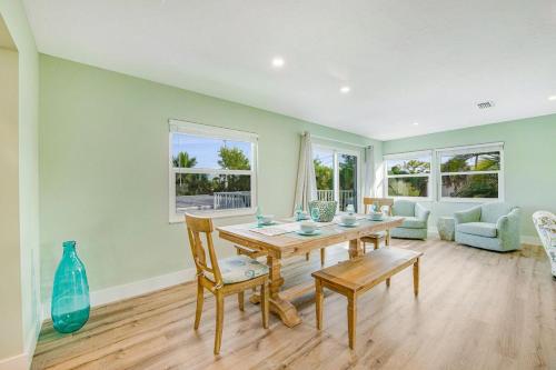a dining room with a table and a couch at Siesta Key Island Rentals in Siesta Key