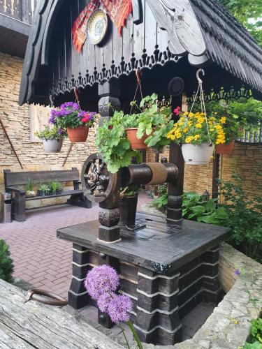 a water fountain with flowers and plants on it at Curtea Domneasca in Cricova