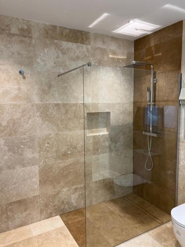a glass shower in a bathroom with a toilet at Superb 3 Bedroom Apartment in Gzira Promenade in Il-Gżira
