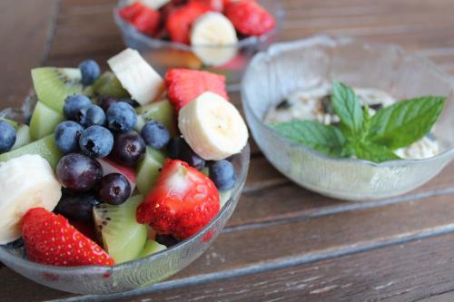 two bowls of fruit on a wooden table at Hotel Schönbrunn in Schenna